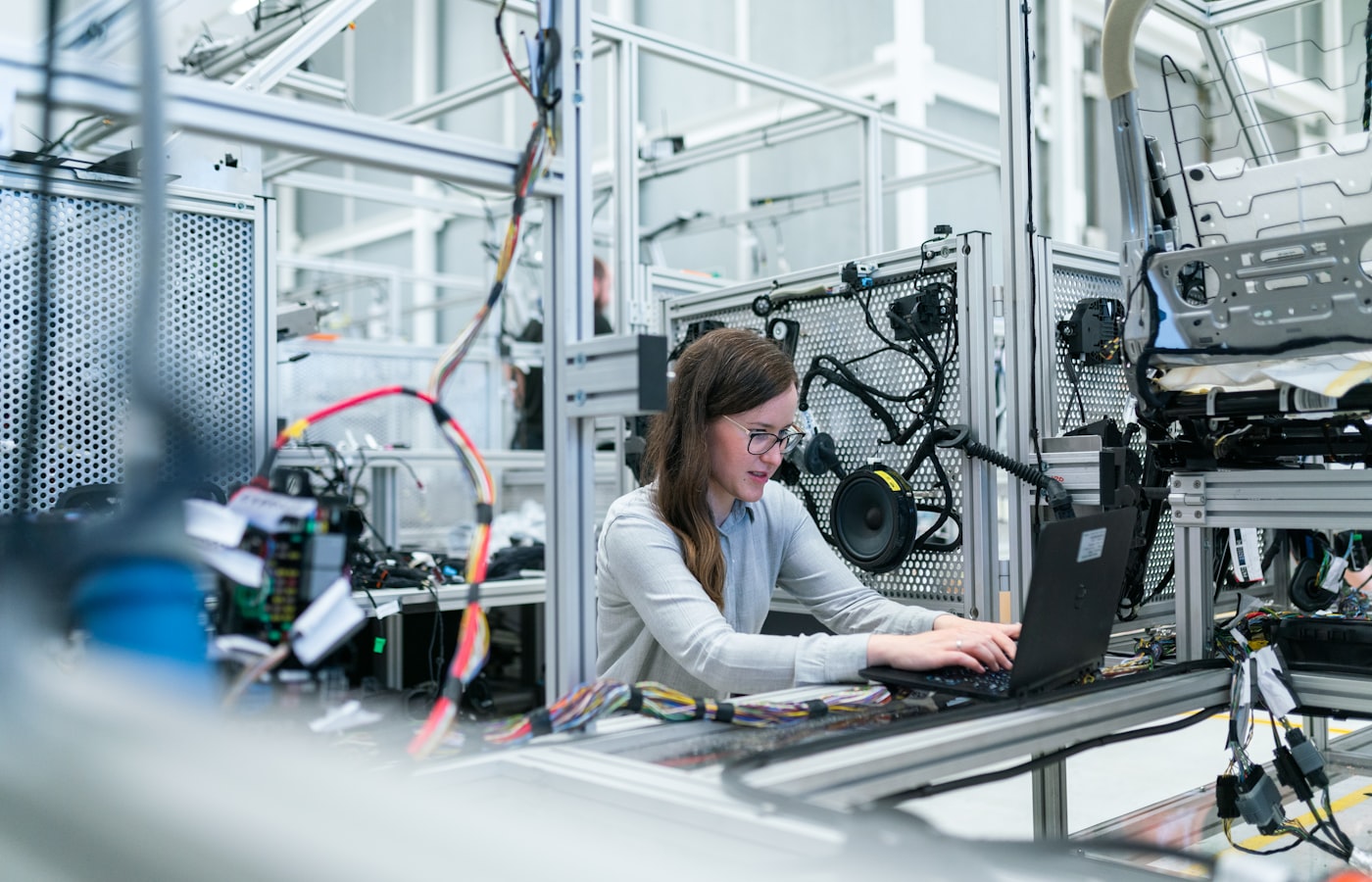 Engineer inspecting equipment on a modern factory floor